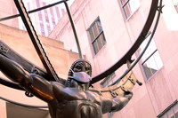 Statue of Atlas wearing a face mask at Rockefeller Center