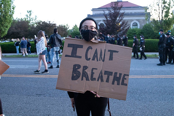 A protester with a sign in Mineola, NY June 1, 202