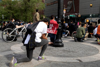 A protester kneels at rally against police violence in Union Square, NYC
