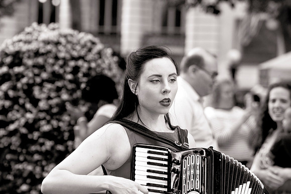 Young woman singing and playing an accordion in Bryant Park, NYC