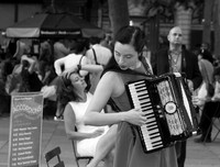 A young woman performing with an accordion in Bryant Park