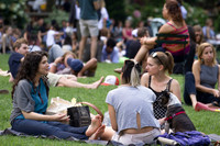 Three friends sitting and eating in Bryant Park
