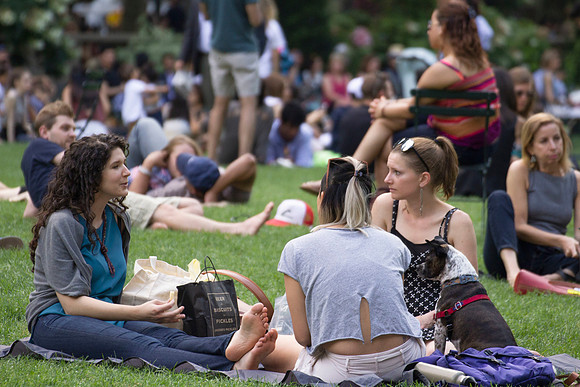 Three friends sitting and eating in Bryant Park