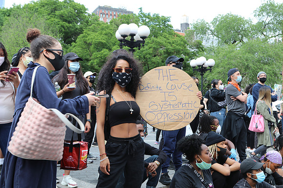 A woman holding a sign during a protest against police violence, Union Square, New York City