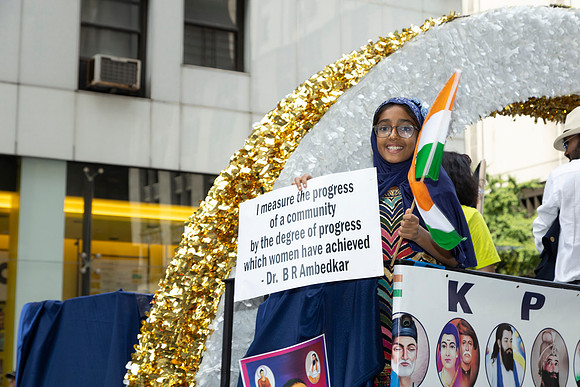 Young girl with a sign at the Indian Day Parade